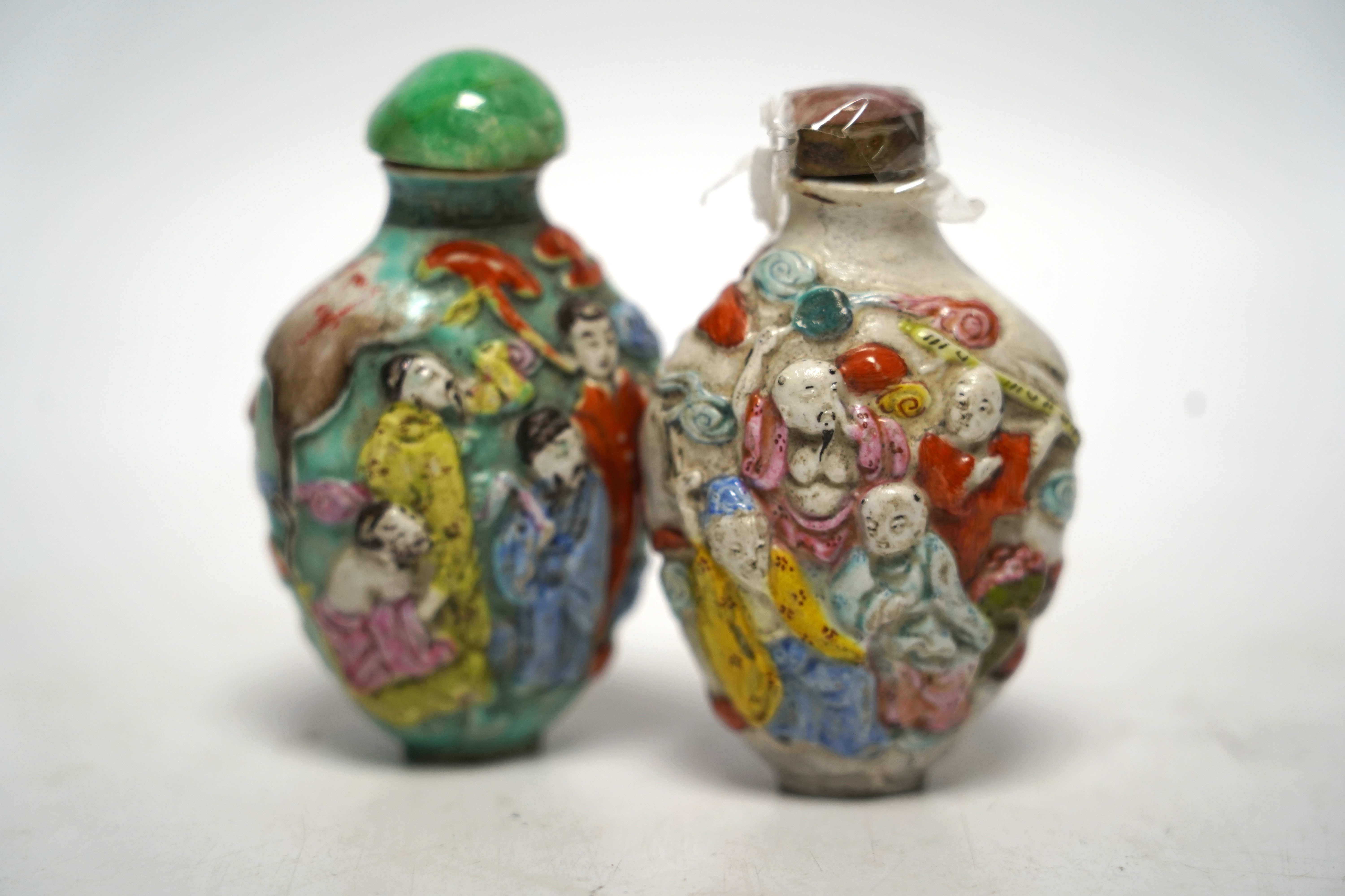 Two 19th century Chinese moulded and enamelled porcelain ’eight immortals’ snuff bottles, largest 8cm high